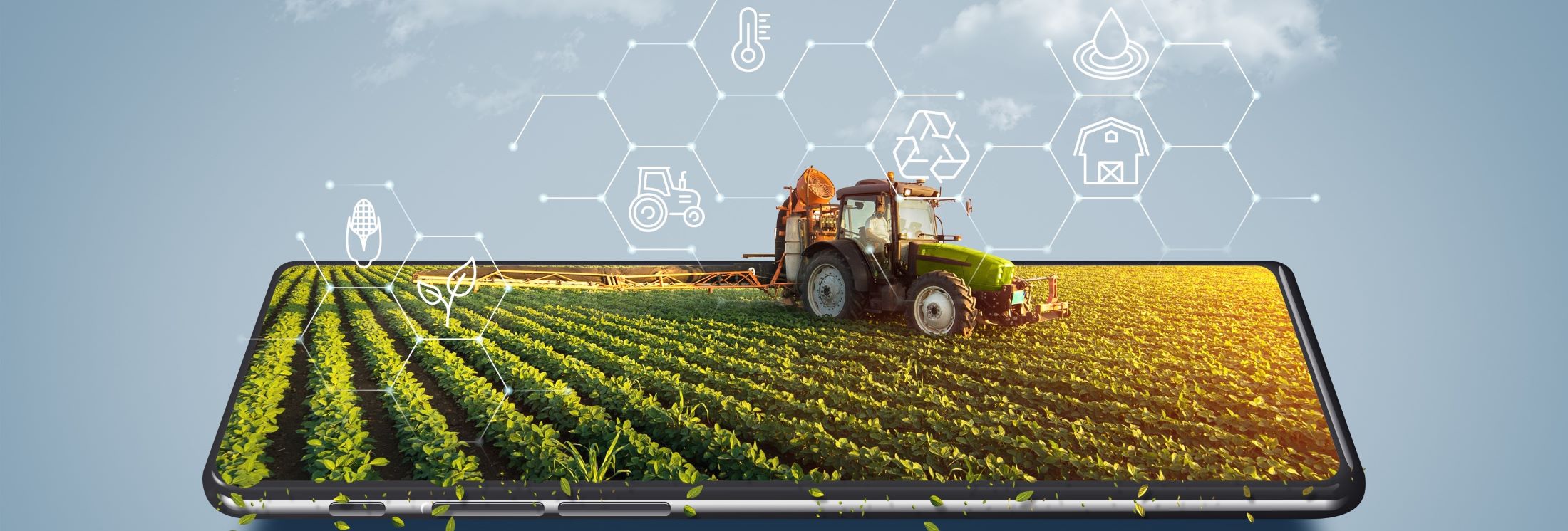 Handy oder Tablett zeigt den Bildschirm als Feld mit einem Traktor und landwirtschaftlichen Symbolen in der Luft