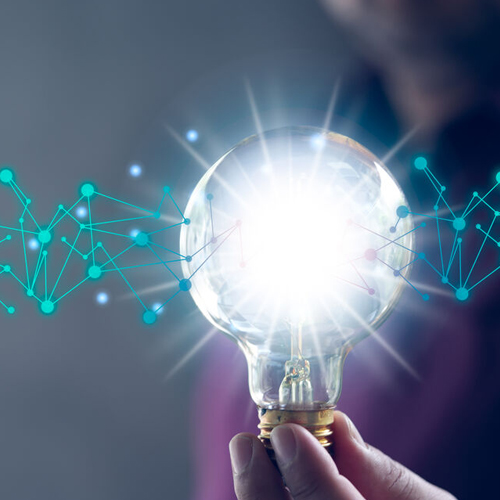 Eine Person präsentiert eine Glühbirne, die von verbundenen Punkten umgeben ist, was innovative Gedanken darstellt.