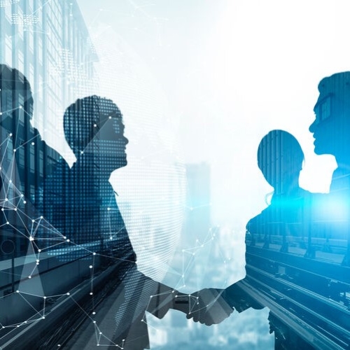 Silhouetten von Geschäftspersonen, die sich die Hand geben, mit überlagerter digitaler Netzwerkgrafik und Stadtansicht im Hintergrund.