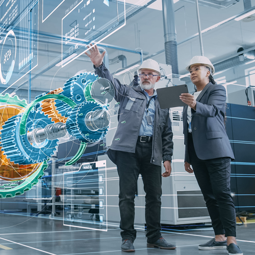 Ein Mann und eine Frau betrachten eine in einem Hologramm dargestellte Maschine