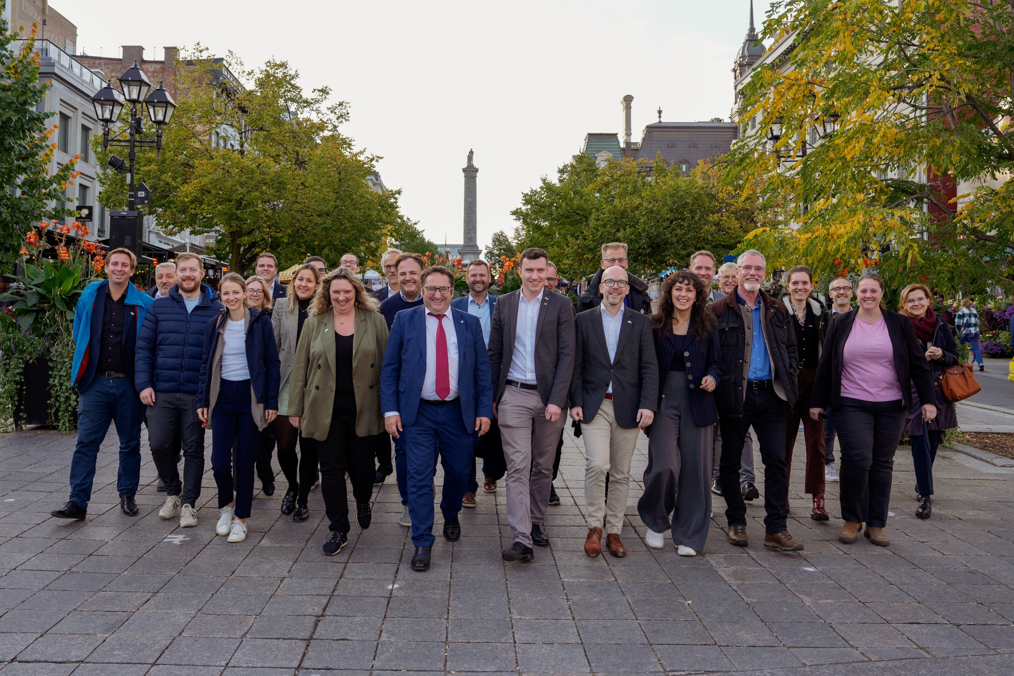 Teilnehmende stehen in einer Straße mit herbstlicher Umgebung, im Hintergrund Gebäude und Bäume. Das Foto wurde während der Delegationsreise in Kanada gemacht.