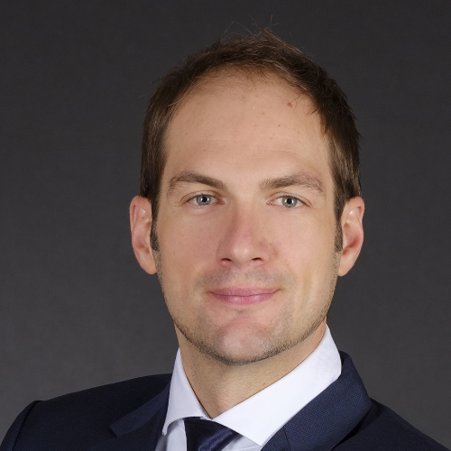 Das Bild zeigt das Portrait von einem Mann im Anzug