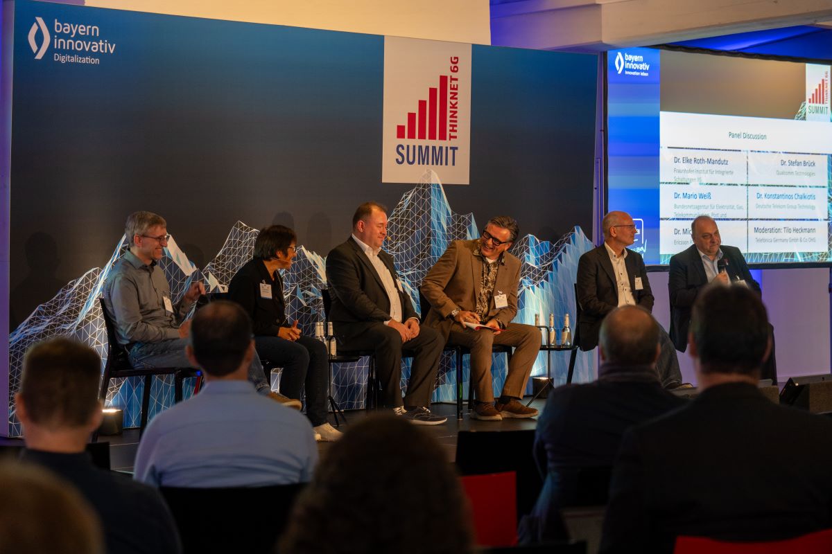 Showing a panel discussion with six people in good mood.