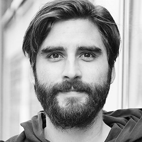 auf dem Bild ist ein Herr mit Bart zu sehen