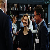 Guests having a fun discussion in front of the coffee bar