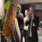 Picture of a person taking a photo with a Polaroid camera.