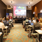 Picture of a panel discussion on a stage.