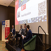 Picture of a panel discussion on a stage.