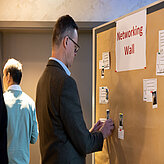 Picture of a participant labelling and using the networking wall.