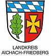 Wappen links Eichelblatt, rechts ein Kreuz, oben Bayern Raute