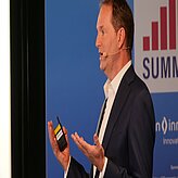 Dr. Willcock on the stage during his presentation