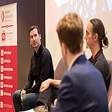 Picture of a panel discussion on a stage.