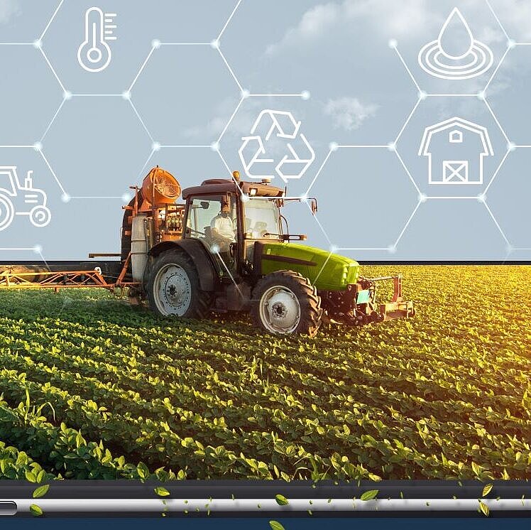 Handy oder Tablett zeigt den Bildschirm als Feld mit einem Traktor und landwirtschaftlichen Symbolen in der Luft