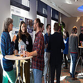 Picture of several people chatting and Networking.