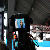 A look through the camera showing a speaker on the stage