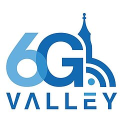 Logo of the 6G Valley. The letters in frotn of a blue church tower, above the WIFI Logo.