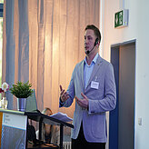 Ein Referierender spricht auf der Bühne