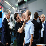 A speaker getting his headset placed by a technician