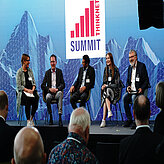 The speakers sitting on the stage and having a seemingly fun discussion