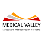 Auf dem Bild ist das Logo von Medical Valley EMN e. V. zu sehen. Medical Valley ist in schwarzen Großbuchstaben geschrieben. Darüber ist eine rot, grau und orangene Grafik.