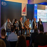 Showing a panel discussion with six people in good mood.